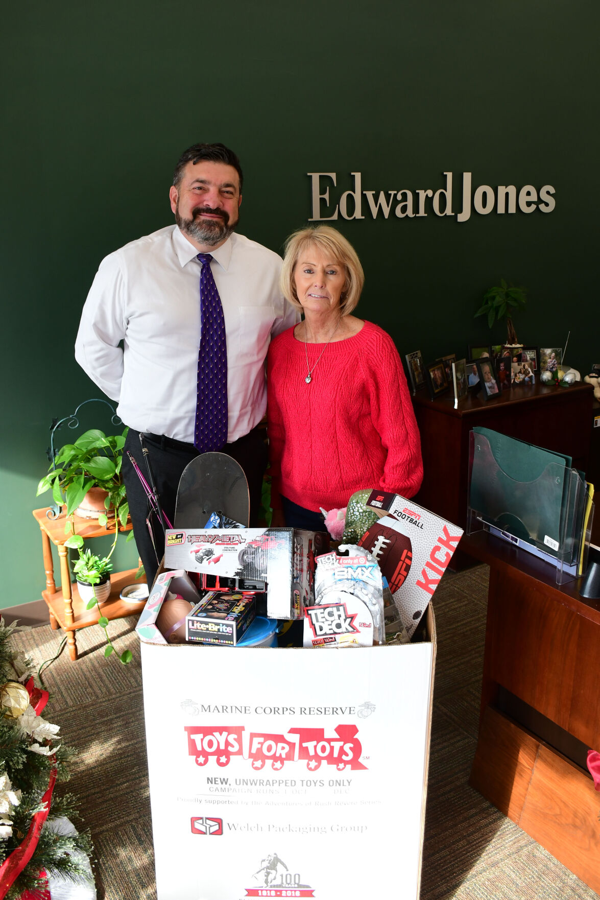 Adams and Kolis pose with a box of toys